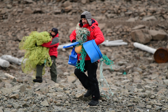 Expedition cruise passengers collecting trash in Svalbard